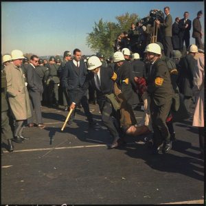 \"lossy-page1-600px-Washington_D.C._Anti-Vietnam_Demonstration._U.S._Marshals_bodily_remove_one_of_the_protesters_during_the_outbreak_of..._-_NARA_-_530620\"
